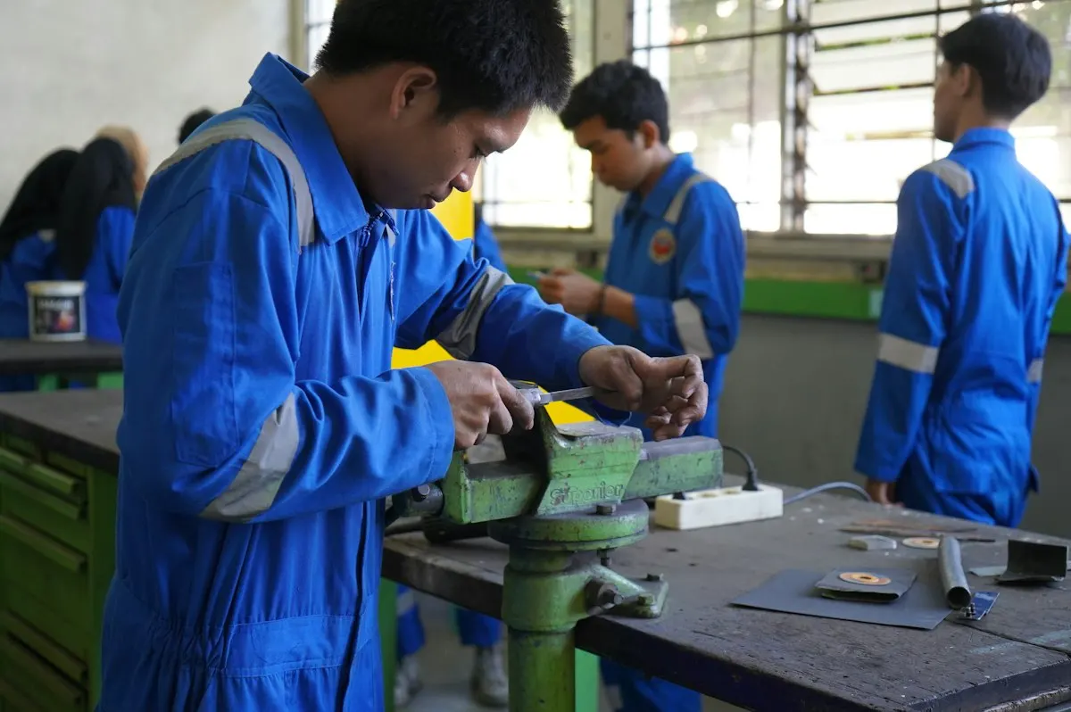 Trainees working on a metal fabrication piece together