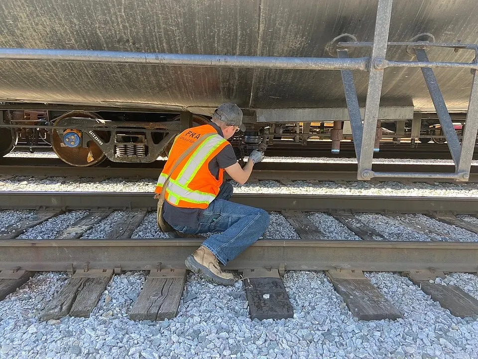 Inspector examining valves on industrial equipment